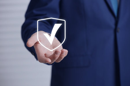 Approved. Man holding virtual check mark in hand, closeupの写真素材