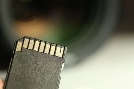 SD memory card on blurred background, closeup. Space for textの写真素材