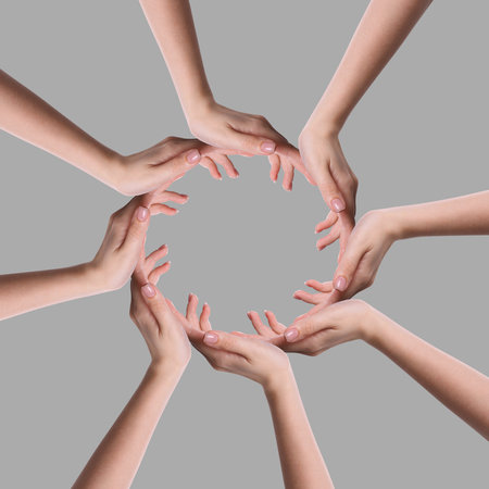 Making circle of human hands on grey background. Unity, partnership, cooperationの写真素材