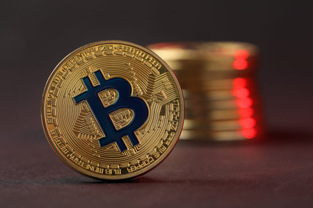 Cryptocurrency. Golden bitcoins on dark background, closeup