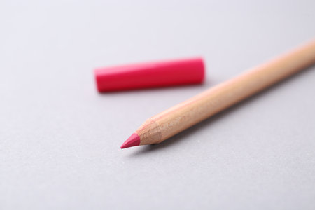 One beautiful lip pencil on light grey background, closeupの写真素材