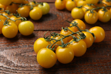 Ripe yellow cherry tomatoes on wooden table, closeupの写真素材