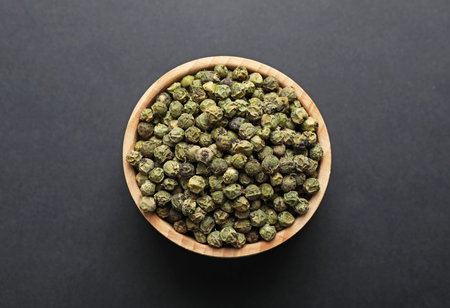 Aromatic pepper in bowl on dark table, top viewの写真素材