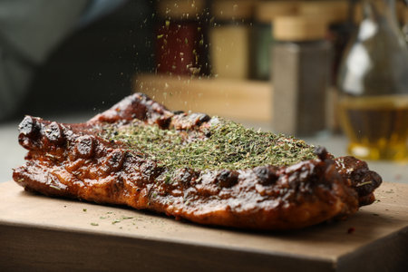 Adding spices to tasty dish at table, closeupの写真素材