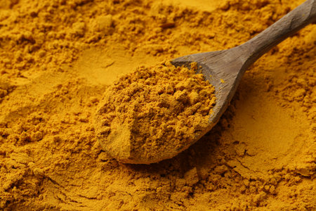 Superfood supplement. Turmeric powder and spoon, closeupの写真素材