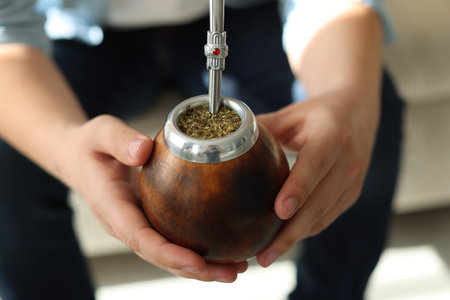 Man with traditional yerba mate tea at home, closeupの写真素材