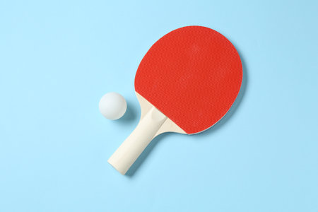 Ping pong racket and ball on light blue background, flat layの写真素材