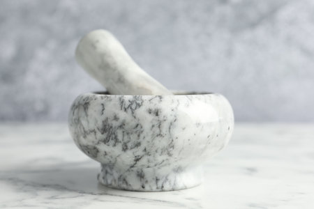 Mortar and pestle on white marble table, closeupの写真素材