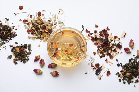 Delicious herbal tea and different brews on white background, flat lay