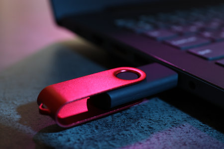 USB flash drive connected to laptop on dark grey table, closeupの写真素材