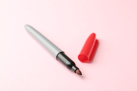 One red marker on light pink backgroundの写真素材