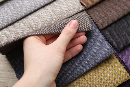 Woman with samples of different fabrics, closeupの写真素材