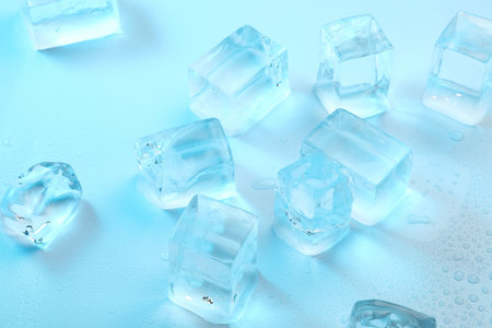 Cubes of clear ice on light blue background, closeupの写真素材