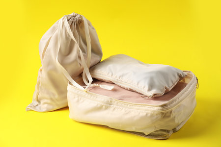 Packing cubes with clothes on yellow backgroundの写真素材