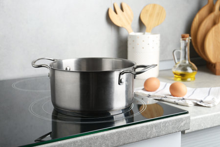 Cooking pot on cooktop indoors. Kitchen utensilの写真素材