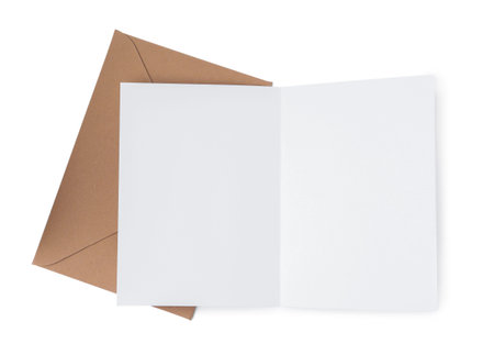 Blank greeting card and paper envelope on white background, top view