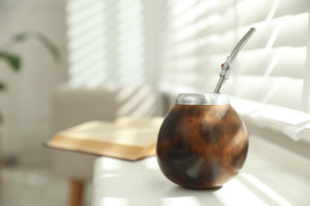 Traditional yerba mate tea on windowsill indoors, closeup