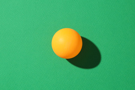 One ping pong ball on green background, top viewの写真素材