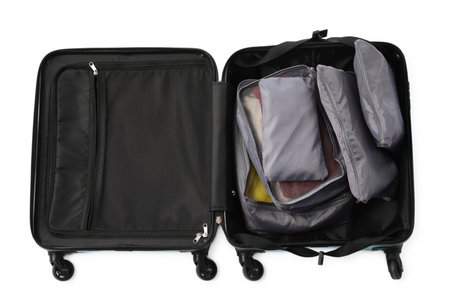 Open suitcase with packing cubes isolated on white, top view