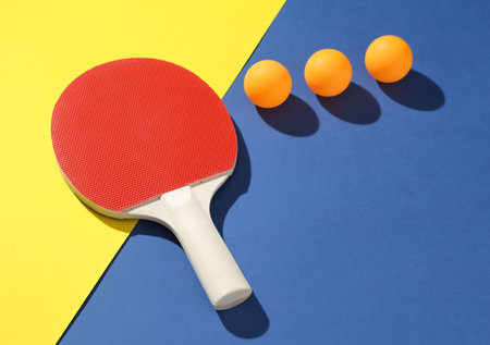 Ping pong racket and balls on color backgroundの写真素材