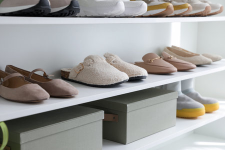 Different footwear on shelves indoors, closeup. Shoe storageの写真素材