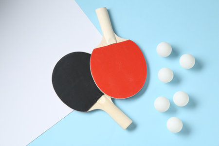 Ping pong rackets and balls on color background, flat layの写真素材