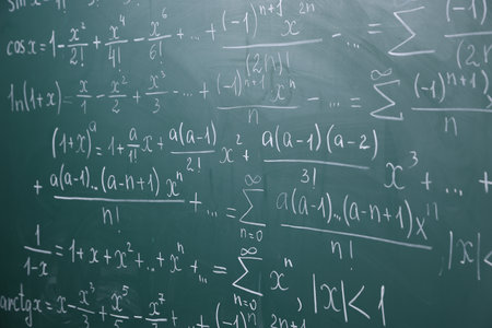 Different formulas written with chalk on blackboardの写真素材