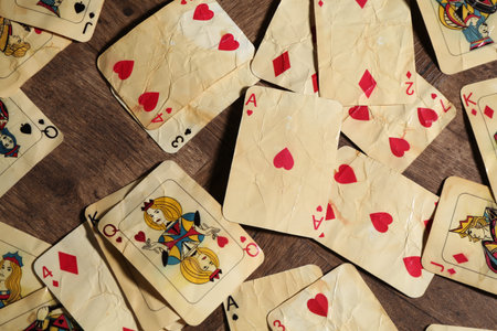 Many old vintage playing cards on wooden table, flat layの写真素材