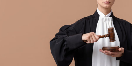 Judge with mallet and sound block on light brown background, closeup. Space for textの写真素材
