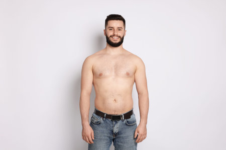 Man after weight loss on light backgroundの写真素材
