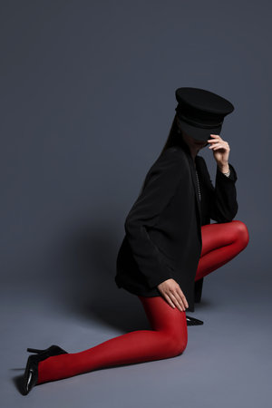 Fashionable portrait of beautiful woman in stylish outfit on grey background. Space for textの写真素材