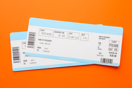 Travel agency. Flight tickets on orange background, top viewのeditorial素材