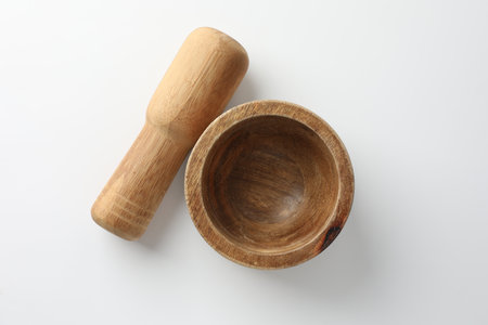 Wooden mortar with pestle on white background, flat layの写真素材