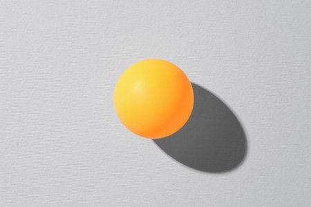 One ping pong ball on light background, top viewの写真素材