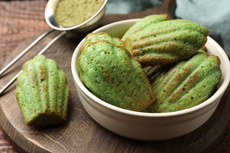 Tasty matcha madeleine cakes on wooden table, closeupの写真素材