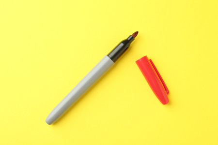 Two markers on yellow background, top viewの写真素材