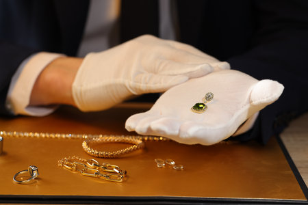 Appraiser working with luxury earring at table, closeupの写真素材