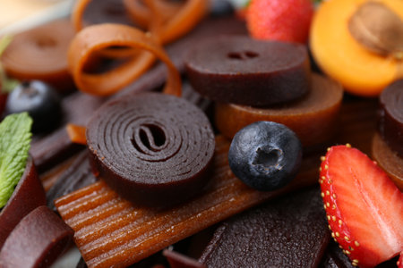 Tasty candied leather rolls, fruits and berries, closeupの写真素材
