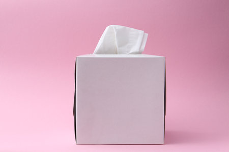 Box with paper handkerchiefs on pink backgroundの写真素材