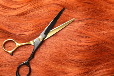 Scissors on hair lock, top view. Space for textの写真素材