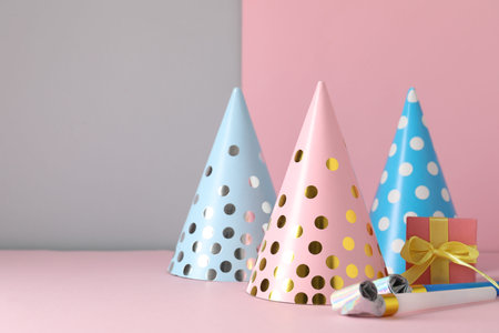 Party hats and festive decor on color background. Space for text