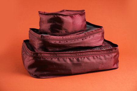 Packing cubes with clothes on bright orange backgroundの写真素材