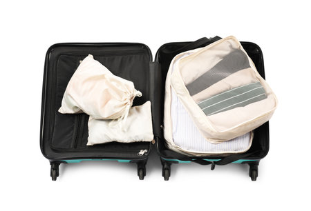 Open suitcase with packing cubes isolated on white, top viewの写真素材