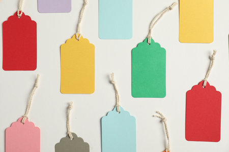 Blank tags with strings on white background, flat layの写真素材