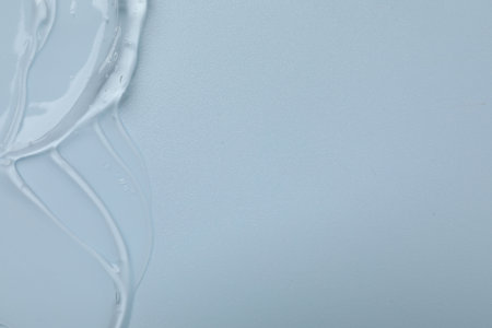 Collagen gel on light blue background, top view. Space for text
