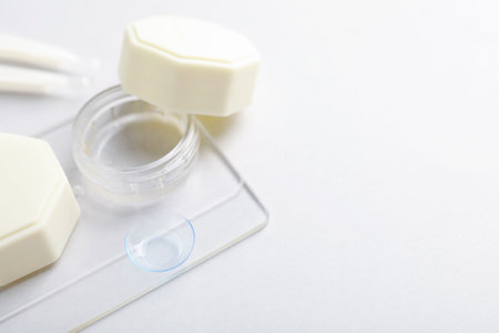 Case with contact lenses on white background, closeup. Space for textの写真素材