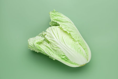 One fresh Chinese cabbage on green background, top view