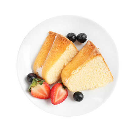 Pieces of tasty bundt cake with berries isolated on white, top view