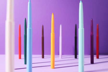 Colorful twist up eye pencils on purple background, selective focusの写真素材
