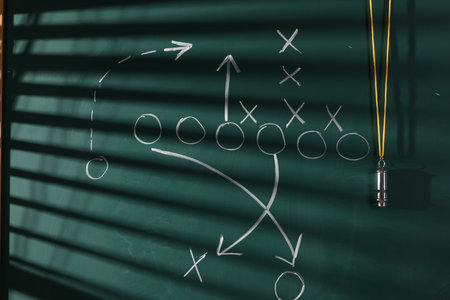 Chalkboard with scheme of American football game and whistleの写真素材